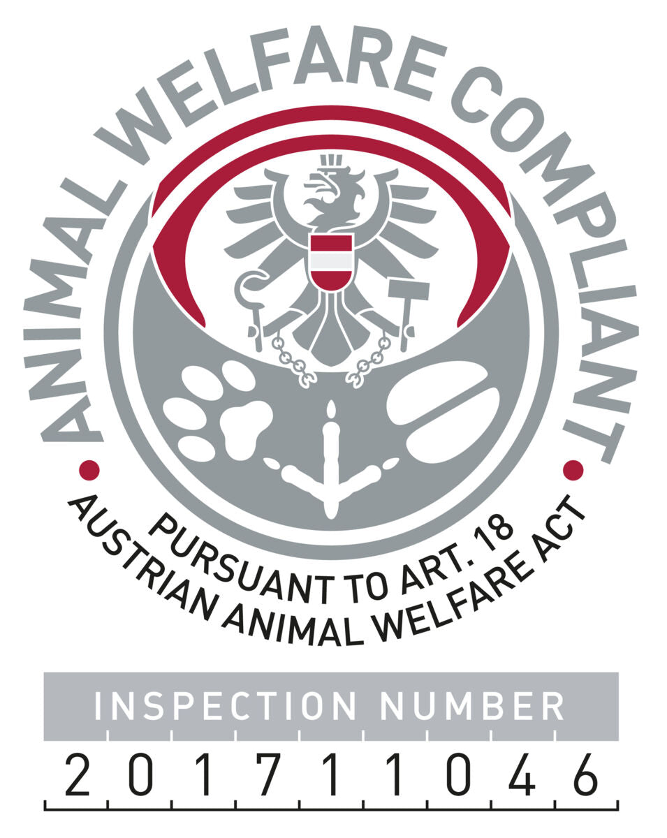 Siegel mit Adler-Emblem, rotem und grauem Kreis, Text: "Animal Welfare Compliant" und "Pursuant to Art. 18 Austrian Animal Welfare Act".