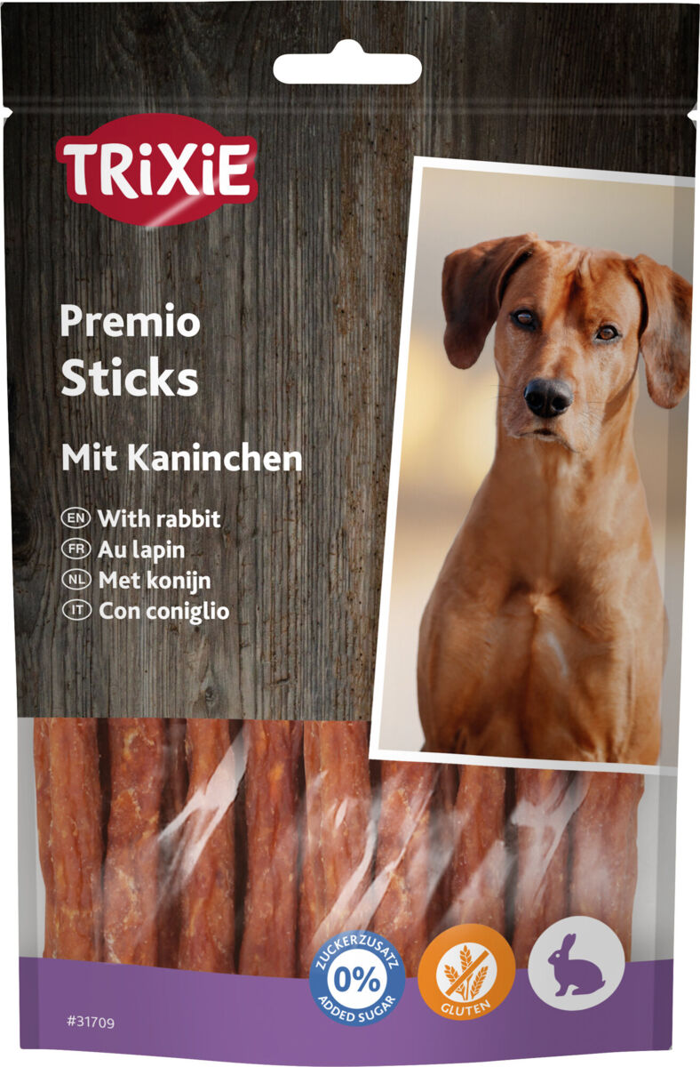 Verpackung von Trixie Premio Sticks mit Kaninchen, daneben Bild eines Hundes und Symbole für zuckerzusatzfrei und glutenfrei.