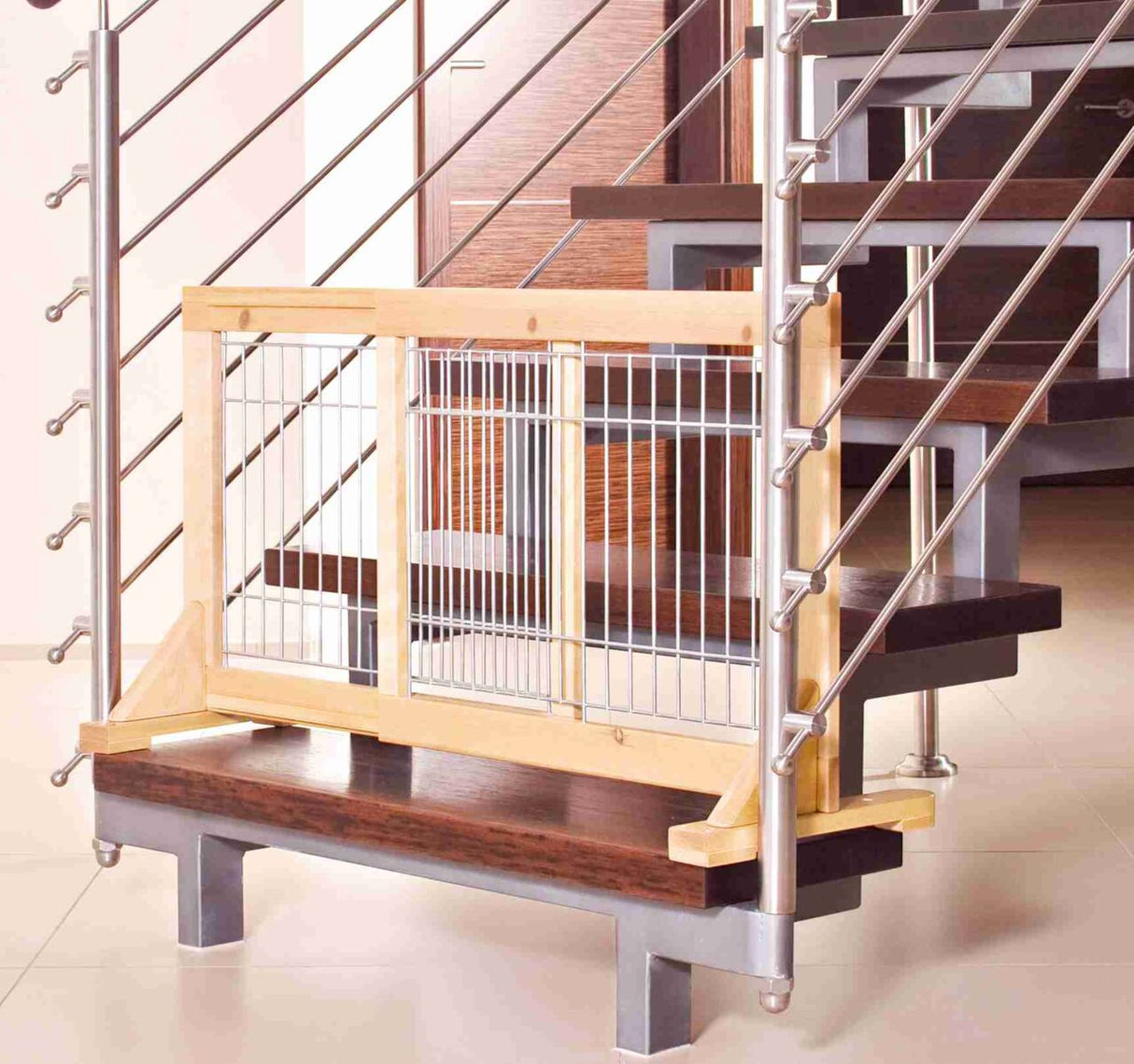 Kinderschutzgitter aus Holz und Metall an einer modernen Treppe mit dunklen Stufen und Metallgeländer.