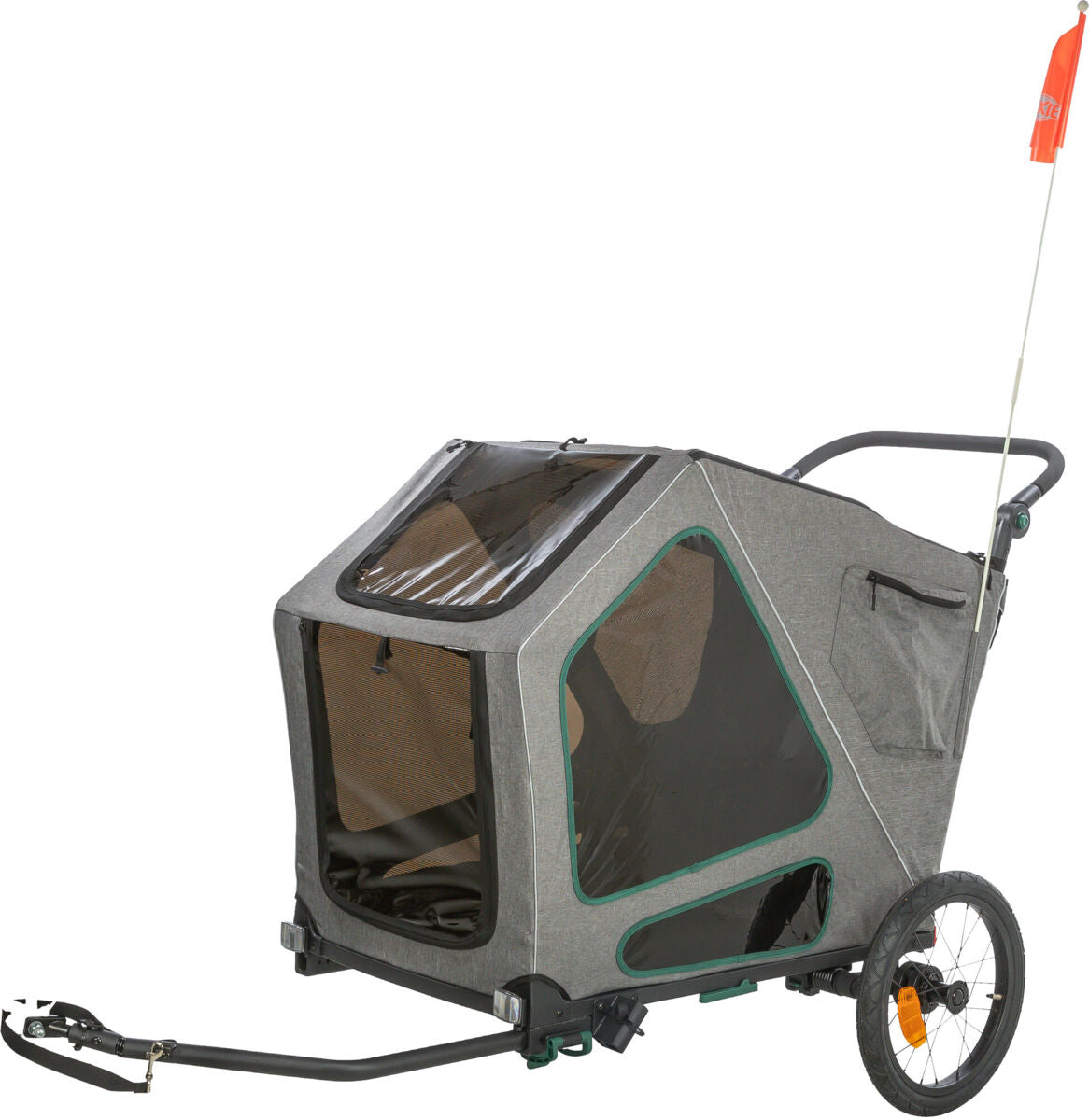 Grauer Fahrradanhänger mit schwarzen und grünen Details, großen seitlichen Fenstern und einer orangefarbenen Fahne.