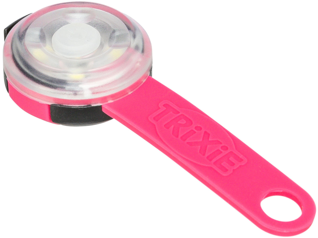Rundes transparentes Leuchtgerät mit pinkem Griff und der Aufschrift "TRIXIE".