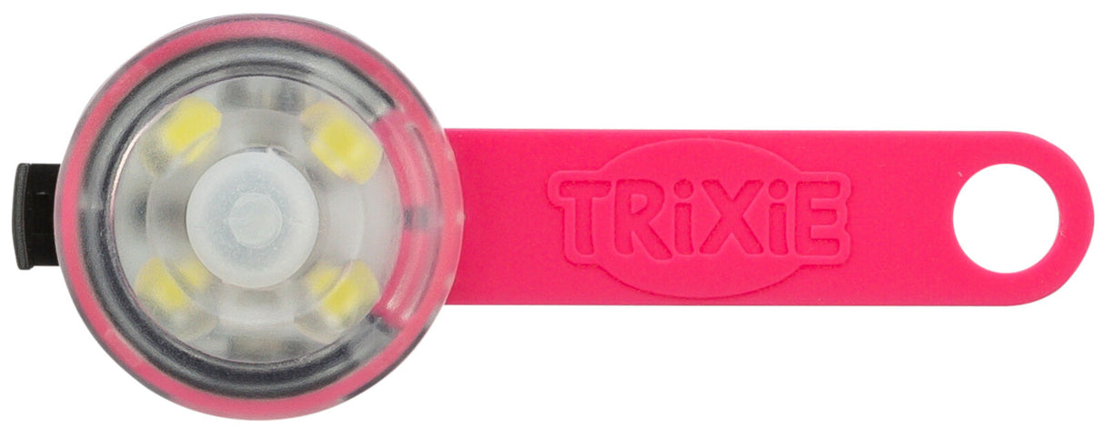 Rundes, kleines Leuchtmittel mit transparentem Gehäuse und einer pinkfarbenen Silikonhalterung mit Loch.