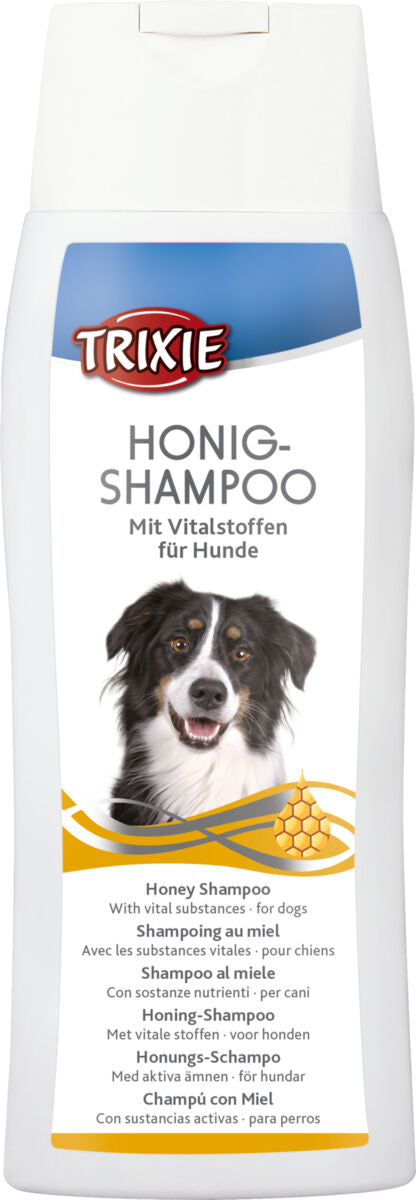 Shampooflasche mit Honigmotiv und Hundebild auf dem Etikett, mehrsprachiger Text weist auf Vitalstoffe für Hunde hin.