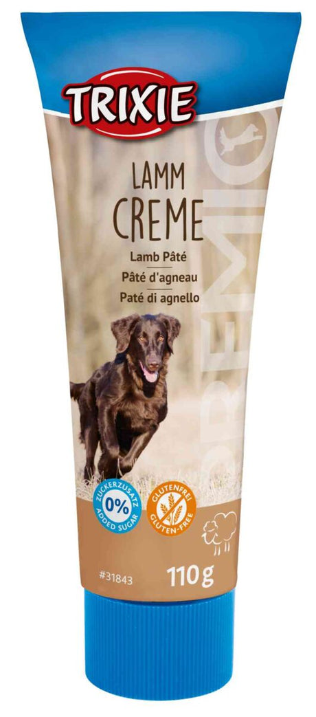 Lamm Creme von Trixie in einer blau-braunen Tube, 110 g, mit Bildern von Hund und Labeln zu Zucker und Glutenfreiheit.