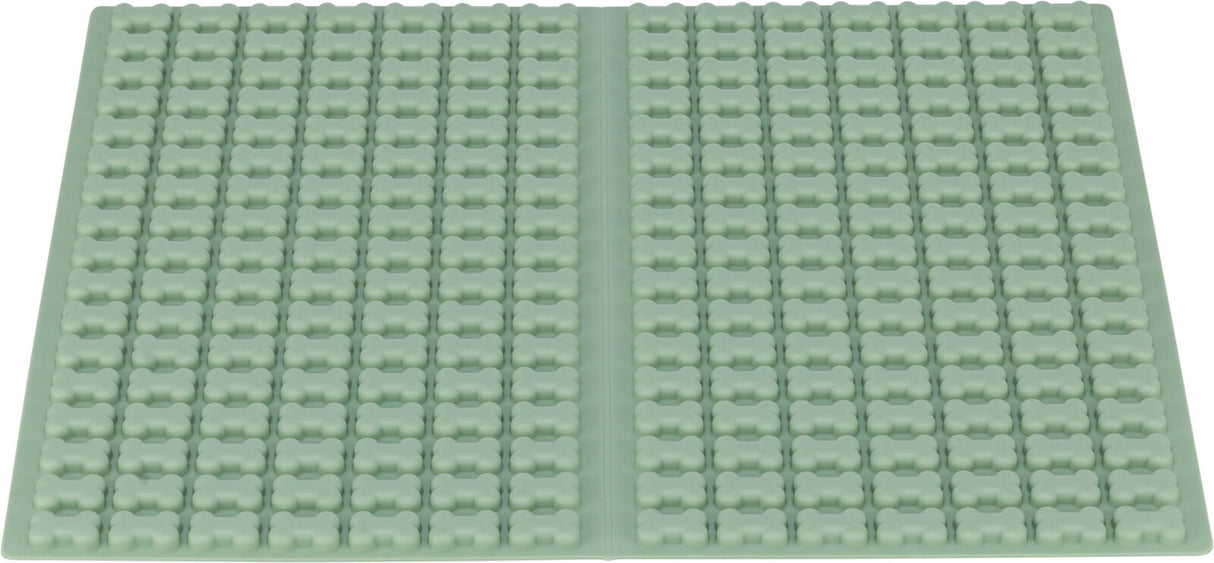 Grüne rechteckige Silikonmatte mit erhobenen, gleichmäßig verteilten Knochenformen darauf.