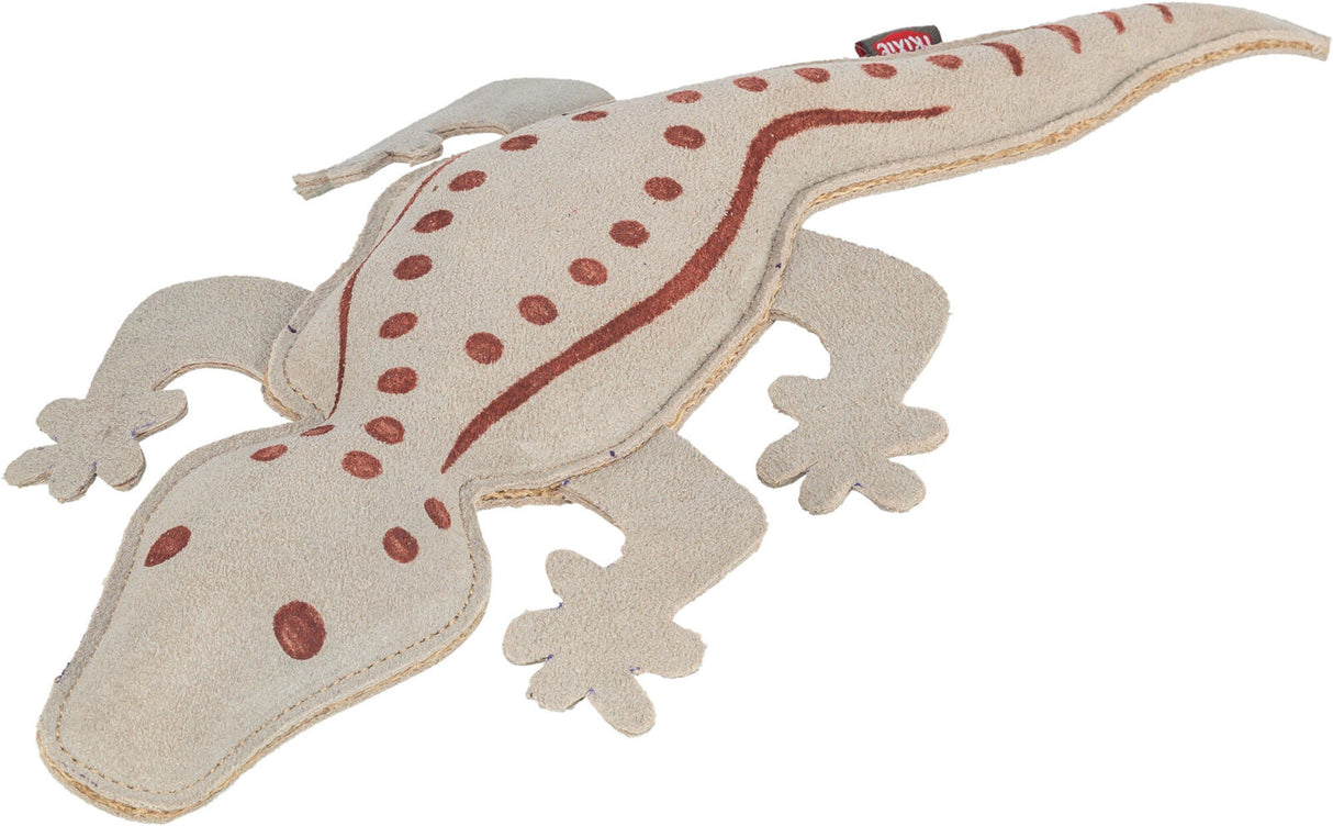 Beigefarbenes Spielzeug in Form einer Eidechse mit braunen Punkten und Linien auf dem Rücken.
