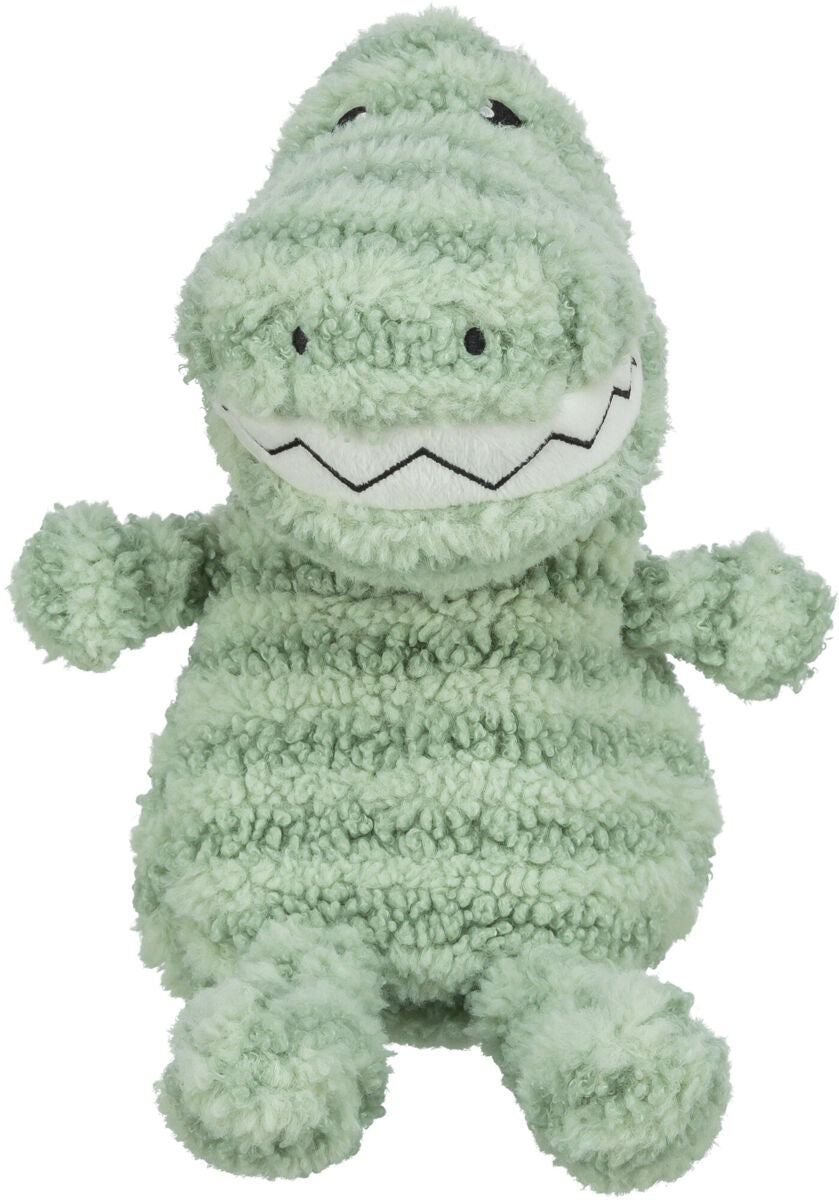 Plüschiges Spielzeug in Form eines Krokodils in hellem Grün mit strukturierter Oberfläche und gesticktem Lächeln.