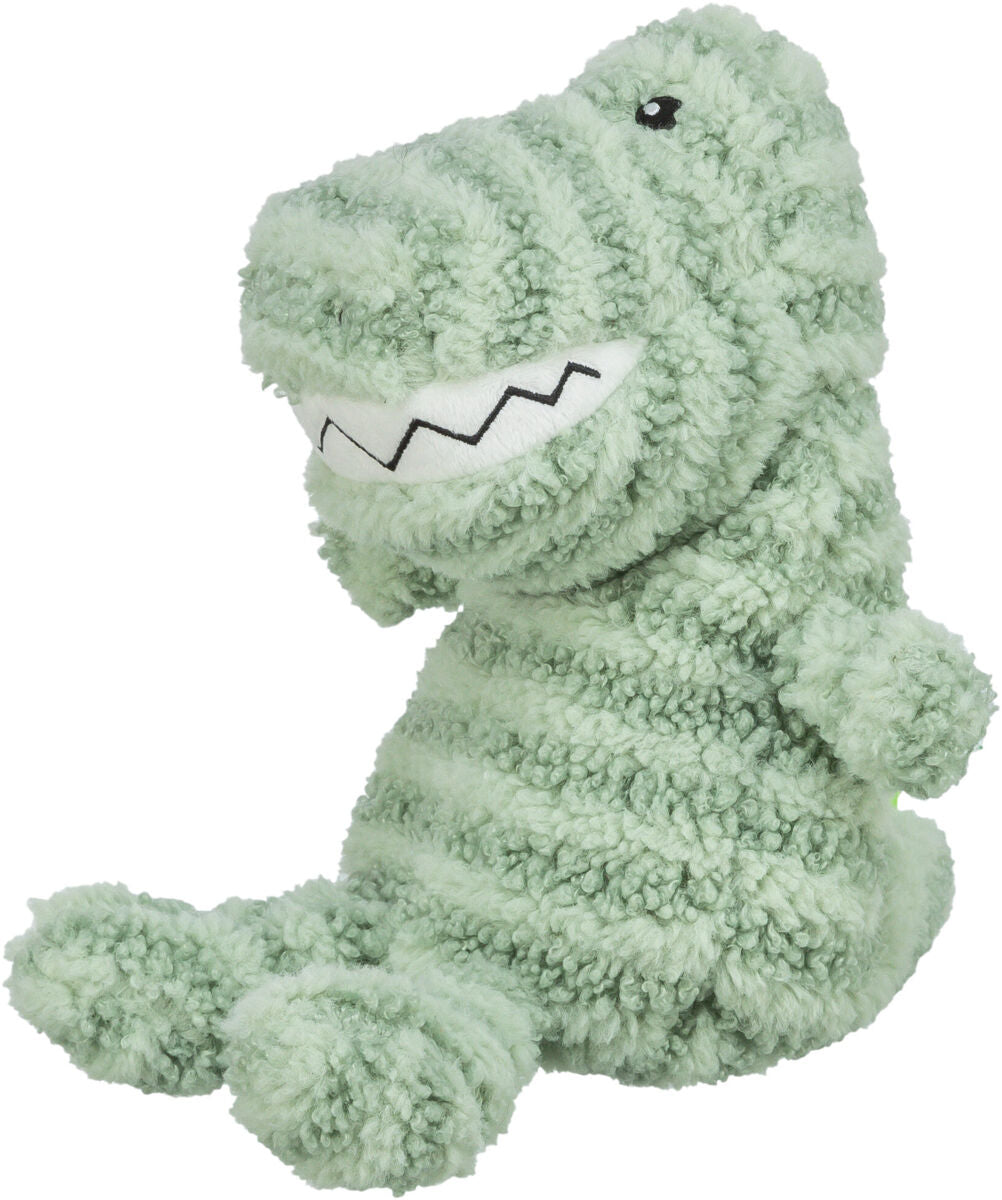 Plüschspielzeug in Form eines grünen Dinosauriers mit schwarzem aufgesticktem Auge und gezacktem Mund.