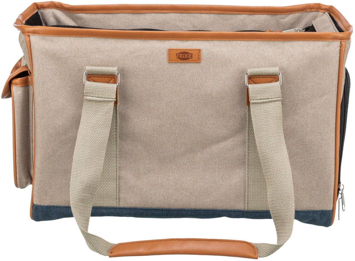Beige Tragetasche mit hellbraunen Details und Griffen, Markenetikett "Trixie" in der Mitte sichtbar.