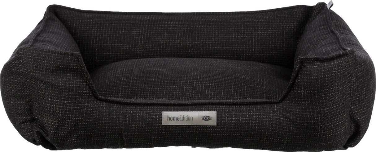 Rechteckiges, dunkelgraues Tierbett mit erhöhtem Rand und aufgenähtem Label "homeEdition Trixie".
