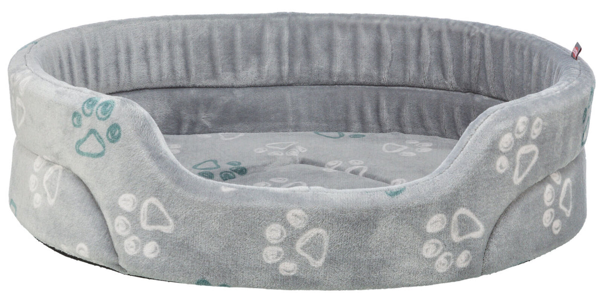 Rundes graues Tierbett mit erhöhtem Rand und Pfotenmuster in Weiß und Grün auf weicher Oberfläche.