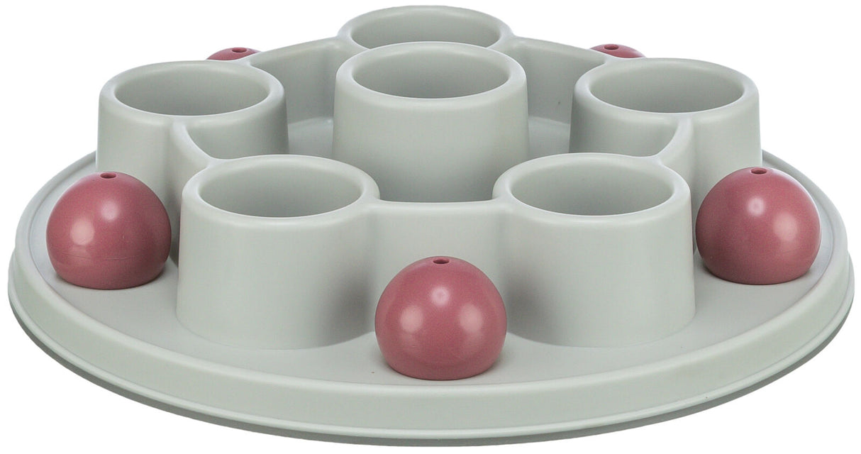 Runder, hellgrauer Kunststoffbehälter mit mehreren vertieften Fächern und rosa Kuppeln auf einer ebenen Oberfläche.