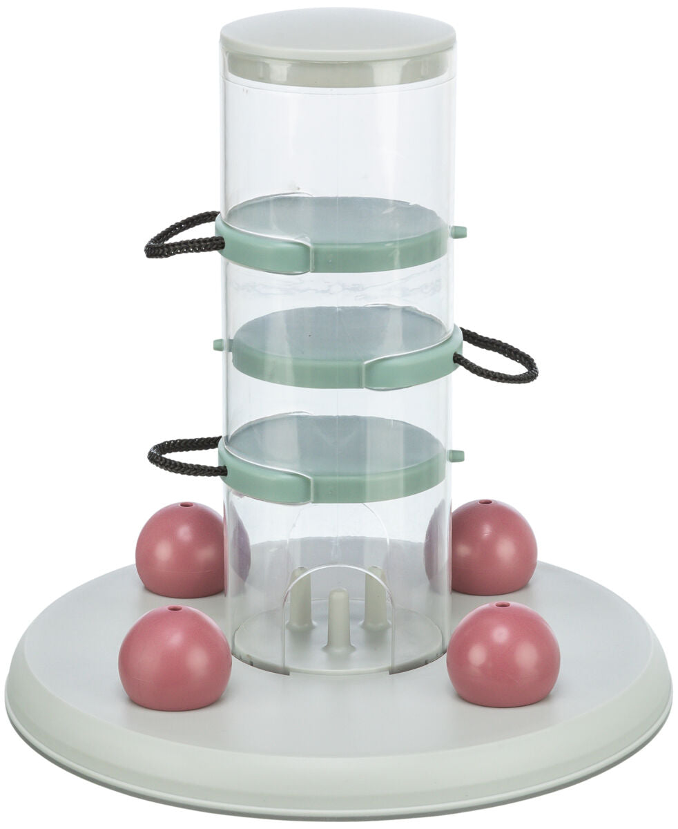 Durchsichtige, zylindrische Vorrichtung mit grünen Halterungen und vier rosa Kugeln auf runder, weißer Basis.