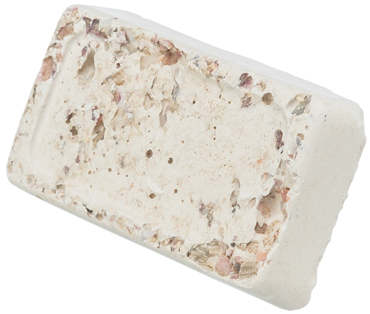 Ein rechteckiger, poröser Block in Beige mit unregelmäßiger Oberfläche und farbigen Partikeln.