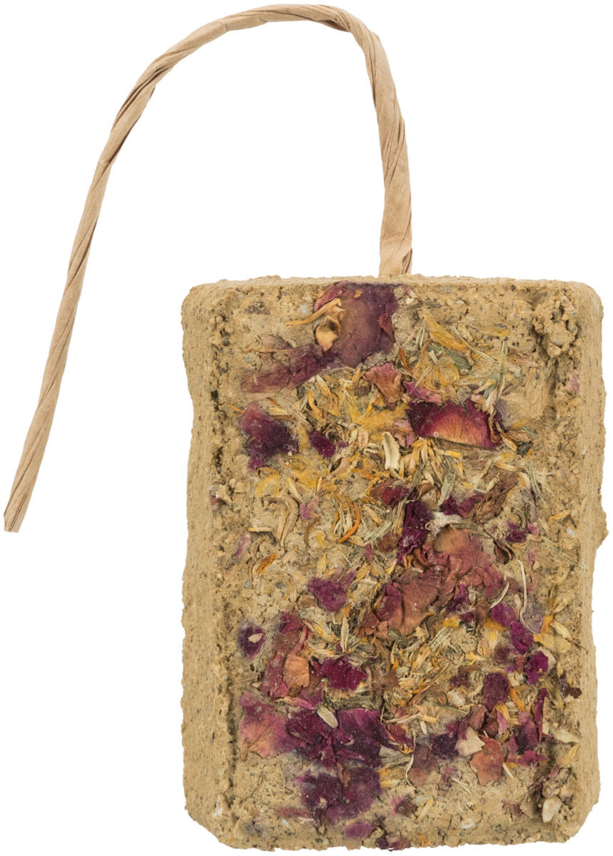 Rechteckiger Block mit getrockneten Pflanzen und Blüten, beige Farbe, oben mit Papierband versehen.