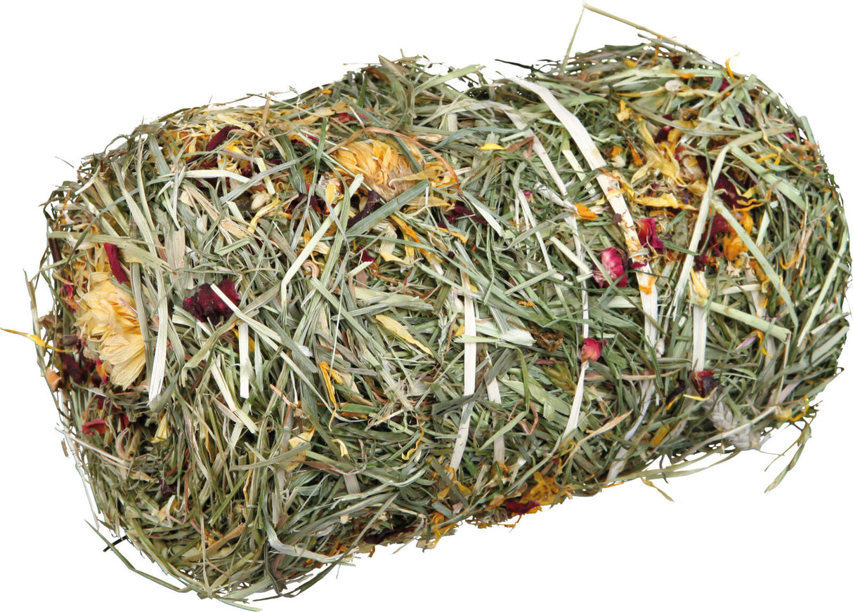 Ein komprimierter Ballen aus getrocknetem Heu und farbigen Blumenblüten, hauptsächlich in Grün- und Gelbtönen.
