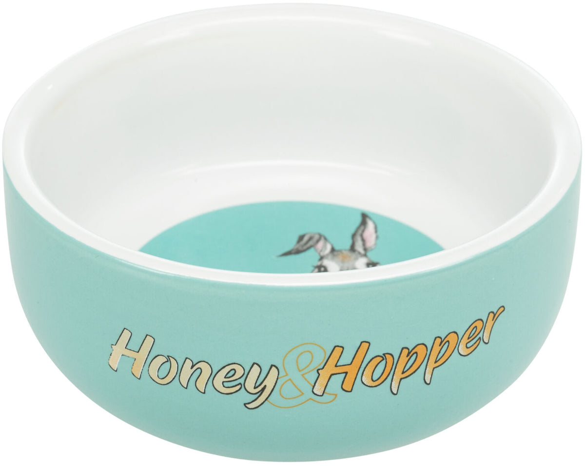 Türkise Schale mit weißem Rand und "Honey & Hopper"-Aufschrift, innen ein Bild mit Tierohren.