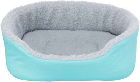 Ovales, türkisfarbenes Tierbett mit grauer, flauschiger Innenpolsterung.