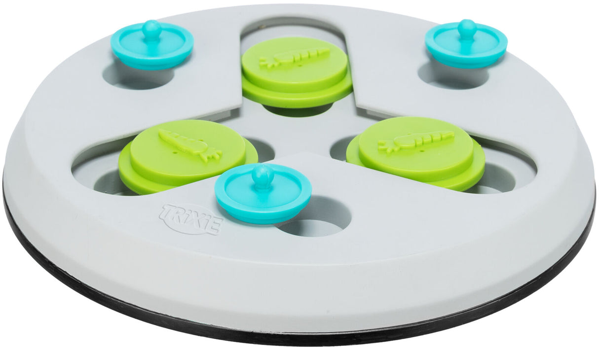 Rundes weißes Spielzeug mit grünen und blauen beweglichen Elementen, die wie Knöpfe aussehen.