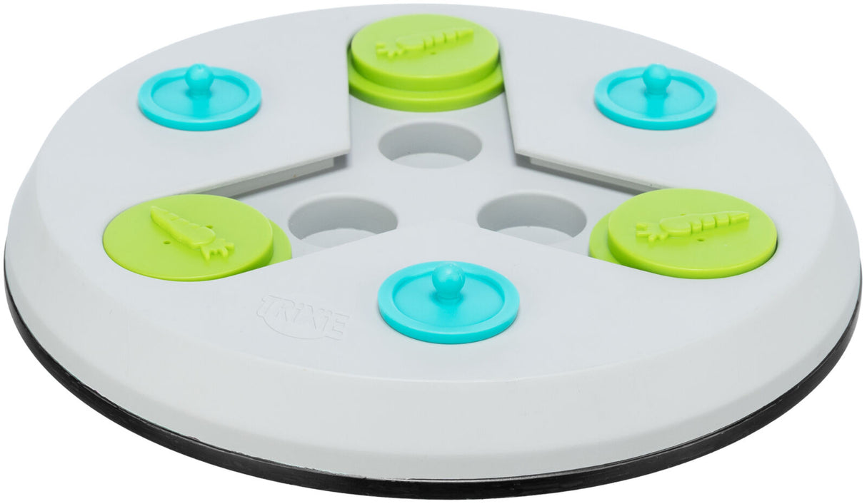 Rundes, weißes Kunststoffspielzeug mit grünen und blauen kreisförmigen Elementen und Karottenmotiv.