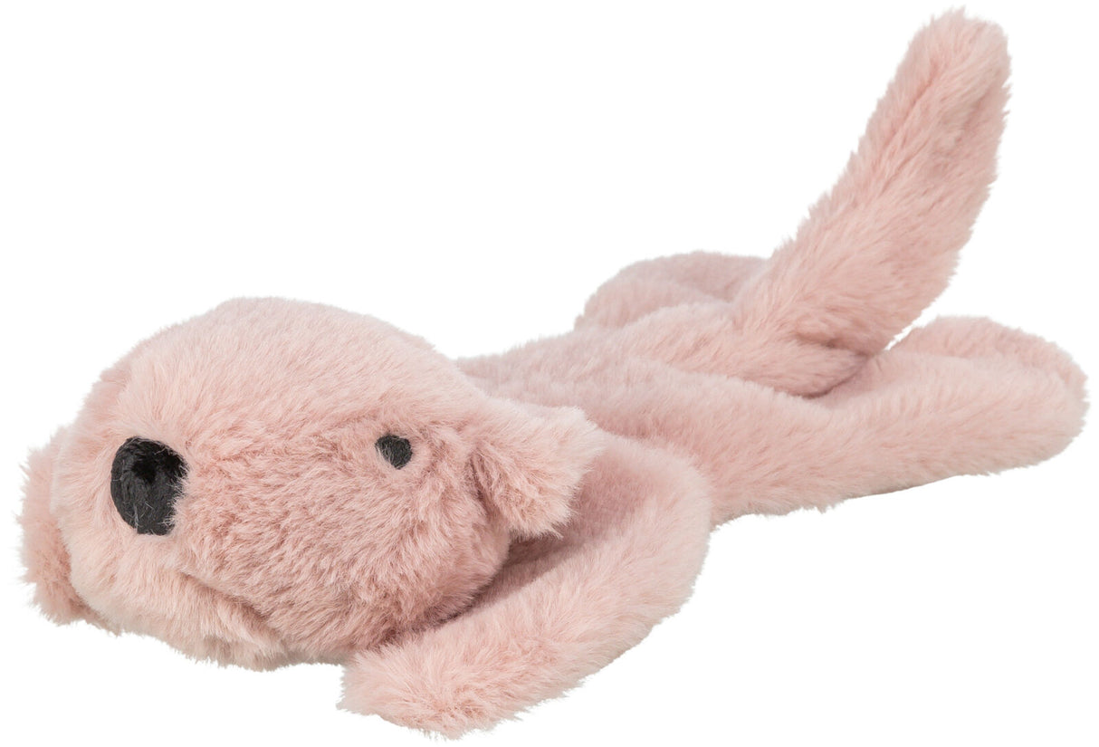 Rosafarbenes, plüschiges Spielzeug in Form eines liegenden Hundes mit schwarzer Nase und Augen.