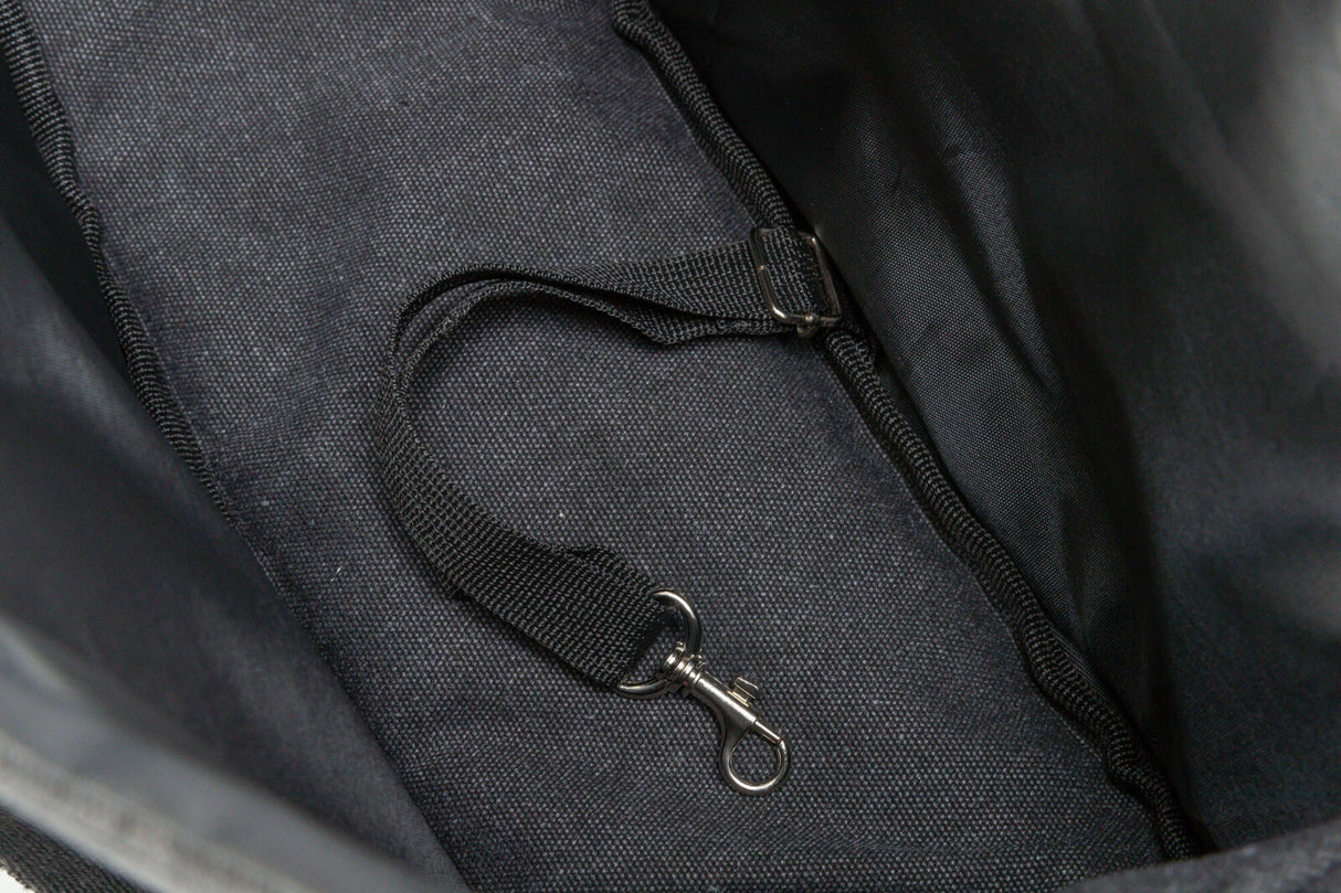 Schwarze Stofftasche mit angenähtem Riemen und silbernem Karabinerhaken im Innenbereich.