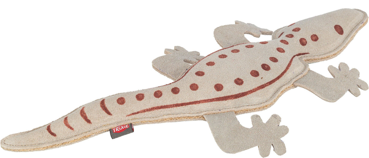 Beigefarbenes Spielzeug in Form einer Eidechse mit braunen Punkten und Streifen, rotes Logo-Label.