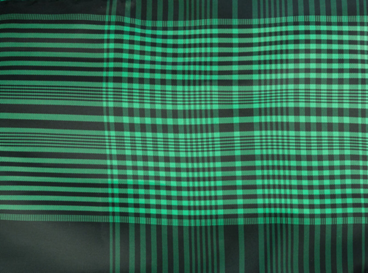 Grünes und schwarzes Karomuster mit vertikalen und horizontalen Streifen in unterschiedlichen Breiten.