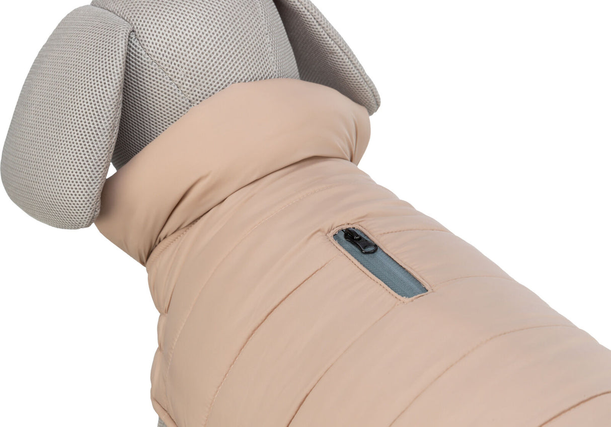 Beigefarbener Hundemantel mit dicker Polsterung und grauem Reißverschluss auf einem Hundemodell.