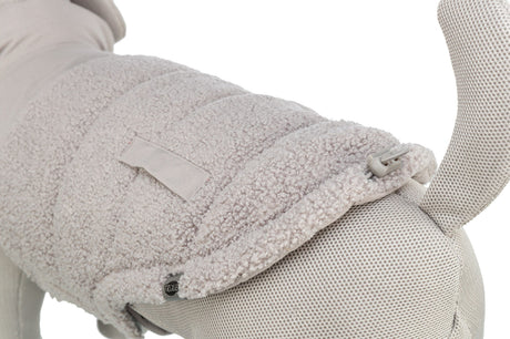 Hellgrauer Hundemantel mit weicher, strukturierter Oberfläche und einstellbarem Verschluss an einem Stoffmodell.