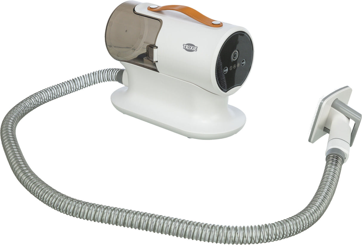 Weißes Gerät mit braunem Griff, durchsichtigem Behälter und flexiblem grauen Schlauch, Aufdruck "TRIXIE".