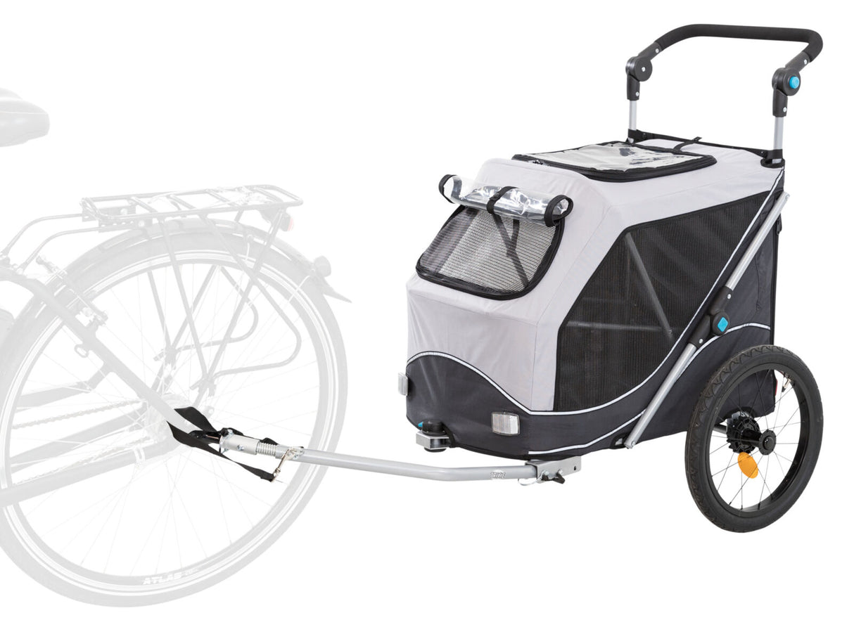 Grauer Fahrradanhänger mit schwarzem Netzfenster und großer seitlicher Stange zur Befestigung an einem Fahrrad.