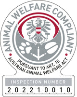 Siegel für Tierschutzkonformität mit Adler und Text "Animal Welfare Compliant" sowie Prüfnummer "202210010".