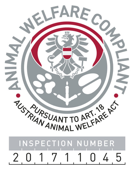 Rundes Logo mit Adler und Text "Animal Welfare Compliant" und "Pursuant to Art. 18 Austrian Animal Welfare Act".