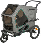 Grauer Fahrradanhänger mit drei Rädern, durchsichtigen Einsätzen und schwarzen Griffen, rechteckige Form.