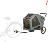 Fahrradanhänger in Grau mit zwei Rädern und transparenter Abdeckung, angekoppelt an ein Fahrrad.