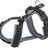 Ein Hundegeschirr aus schwarzem und grauem Material mit verstellbaren Riemen und Metallschlaufen.