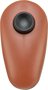 Brauner, ovaler Gegenstand mit einer schwarzen, zentralen Taste auf der Oberfläche.
