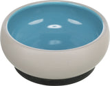 Runde Schüssel mit beige Außenseite und blauer Innenseite, mit schwarzem Boden.