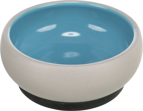Runde Schüssel mit beige Außenseite und blauer Innenseite, mit schwarzem Boden.