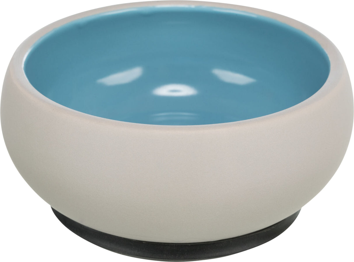 Beigefarbene Schale mit blauer Innenseite und einem dunklen Sockel, schlichtes, modernes Design.
