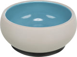 Beigefarbene Schale mit blauer Innenseite und einem dunklen Sockel, schlichtes, modernes Design.