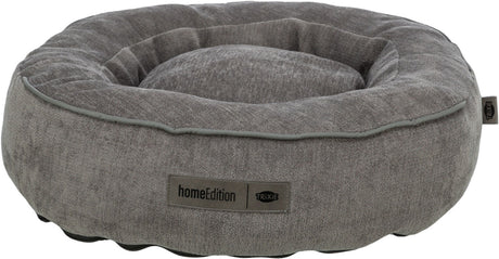 Graues, rundes Hundebett mit erhabenen Rändern, weichem Stoff und einem Etikett mit der Aufschrift "homeEdition Trixie".