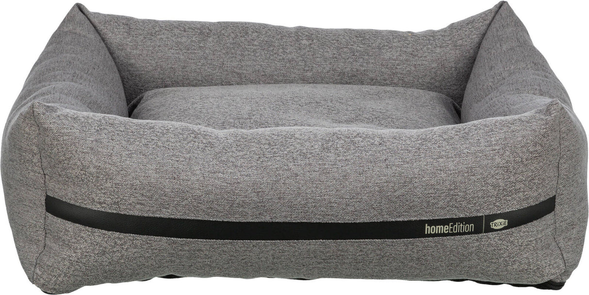 Graues, rechteckiges Hundebett mit erhöhtem Rand, Textur sichtbar, schwarzer Streifen, Aufschrift "homeEdition Trixie".