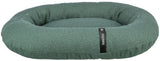 Rundes, grünes Hundebett mit hohem Rand und einer Label-Aufschrift "homeEdition" auf einem schwarzen Streifen.
