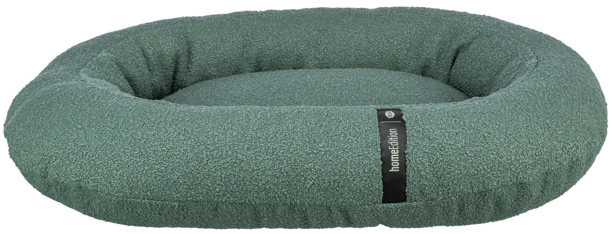 Rundes, grünes Hundebett mit hohem Rand und einer Label-Aufschrift "homeEdition" auf einem schwarzen Streifen.