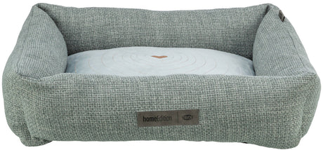 Das Bild zeigt ein rechteckiges, graues Haustierbett aus gewebtem Stoff mit einem hellen Kissen in der Mitte.