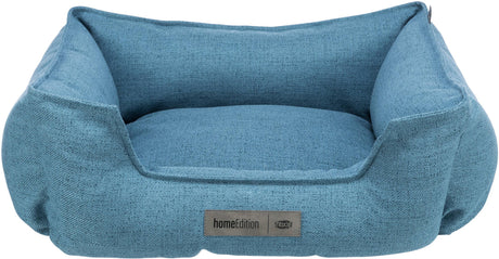 Blaues, quadratisches Haustierbett mit erhöhten Seiten und einem Etikett „homeEdition Trixie“ auf der Vorderseite.