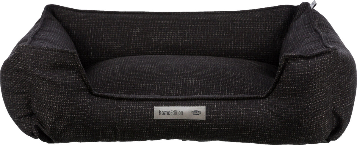 Rechteckiges, dunkelgraues Tierbett mit erhöhtem Rand und aufgenähtem Label "homeEdition Trixie".