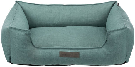 Rechteckiges, türkisfarbenes Haustierbett mit erhöhten Rändern und vorhandenem Etikett an der Vorderseite.